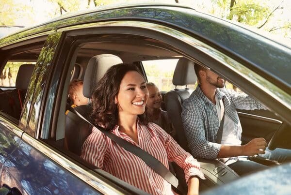 Auto Insurance - Family Driving to a Vacation Destination with Kids in the Back of the Car